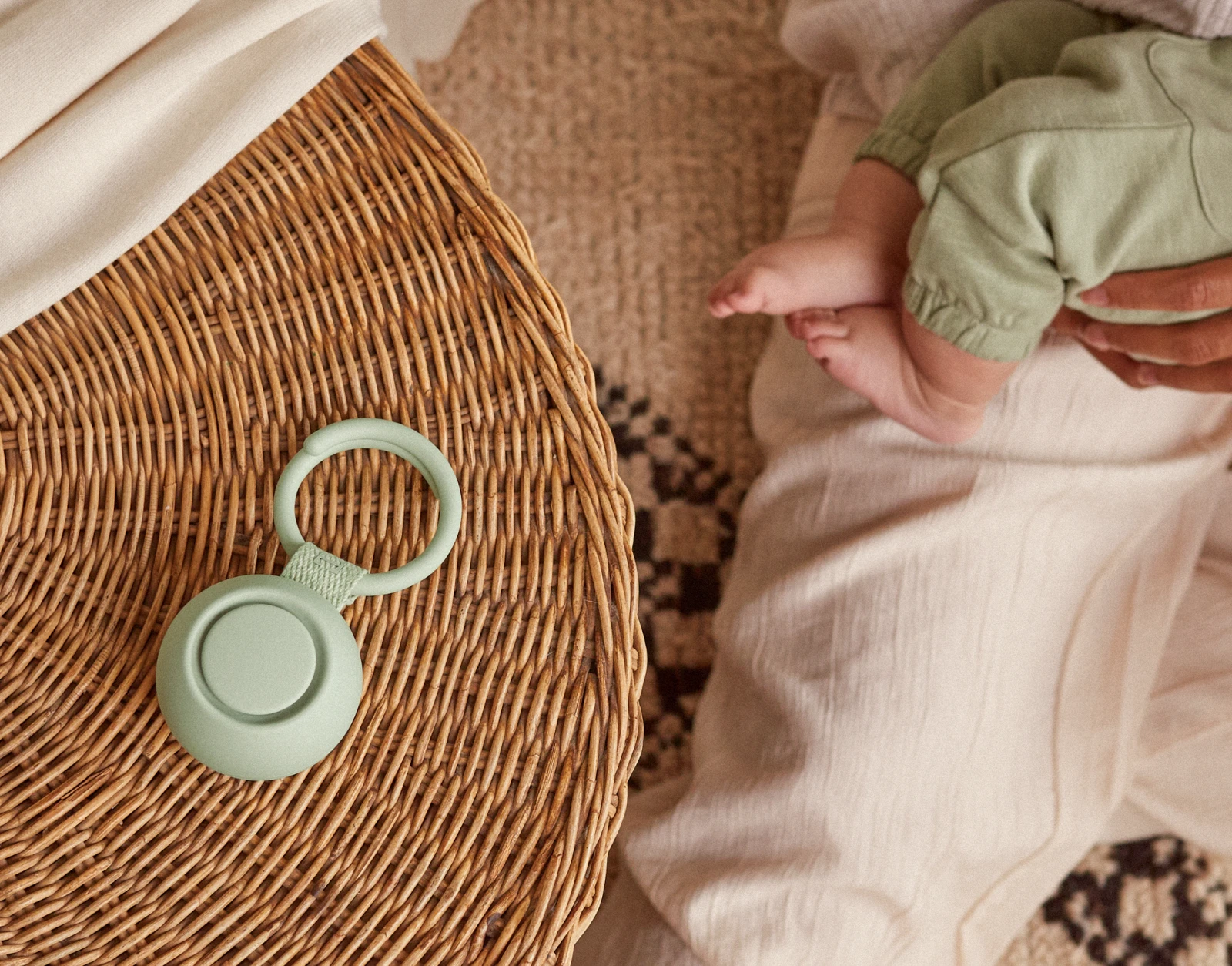 Hatch Go Mint on a table next a mother cradling her baby