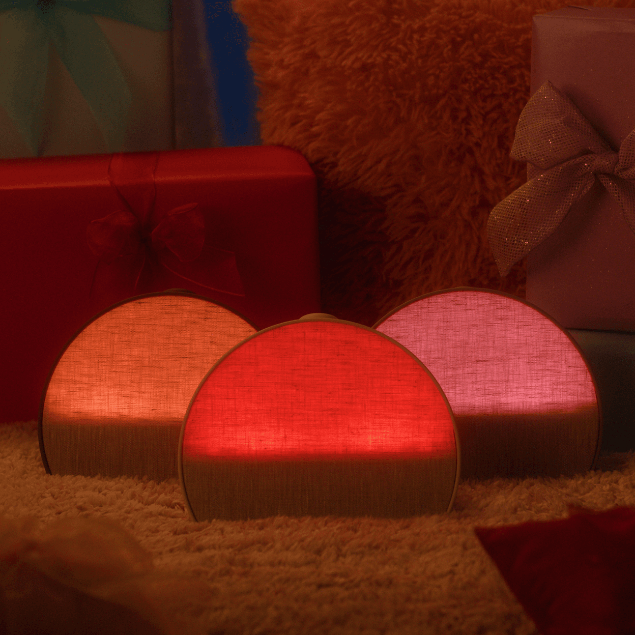 Hatch Restore 3 all 3 colorways sitting on a carpet next to holiday presents