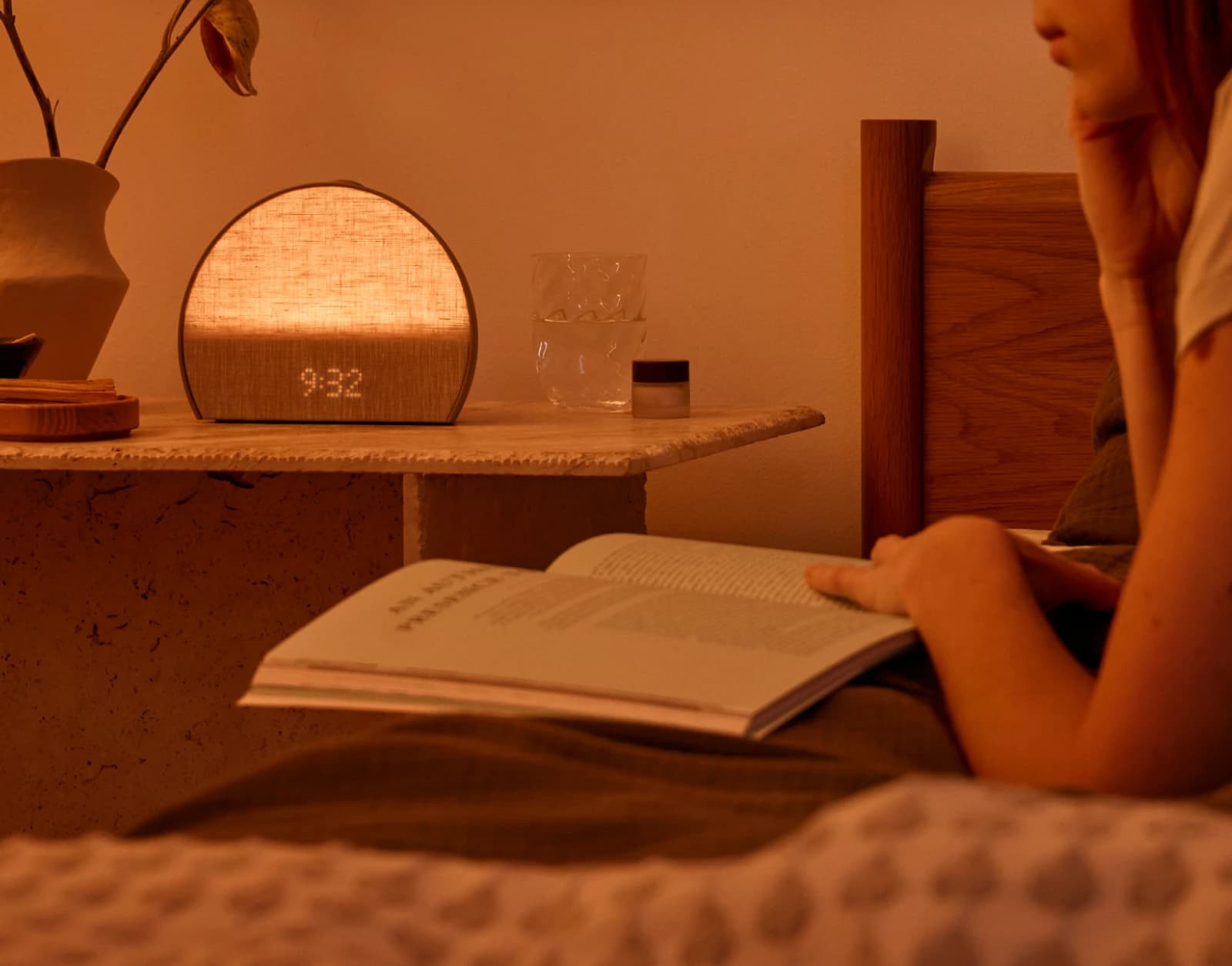 Restore 3 Greige on a nightstand next to someone reading in bed