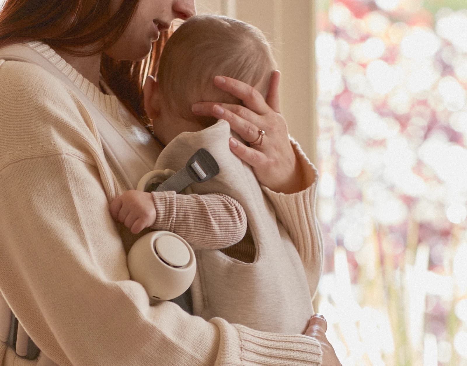 Hatch Go Putty clipped to a front baby carrier with a baby strapped in