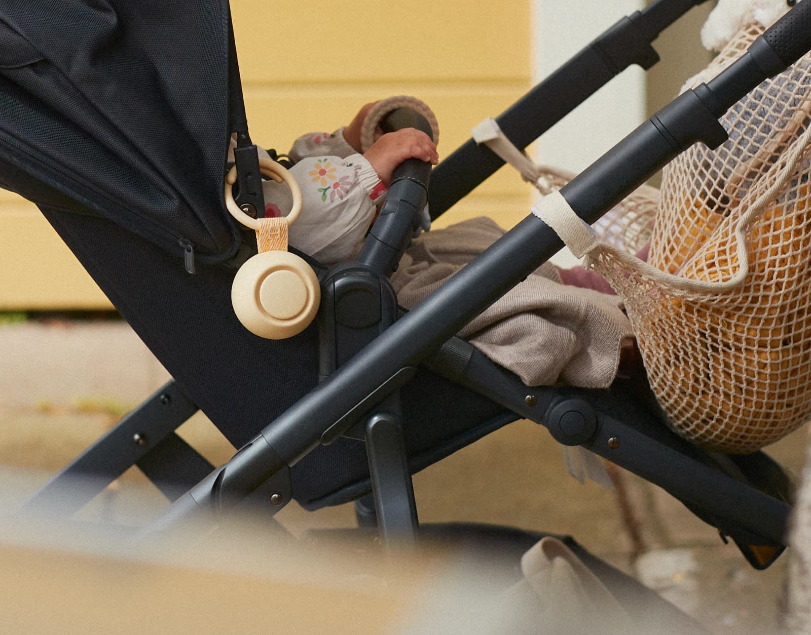 Hatch Go Honey clipped on a stroller with a baby in it